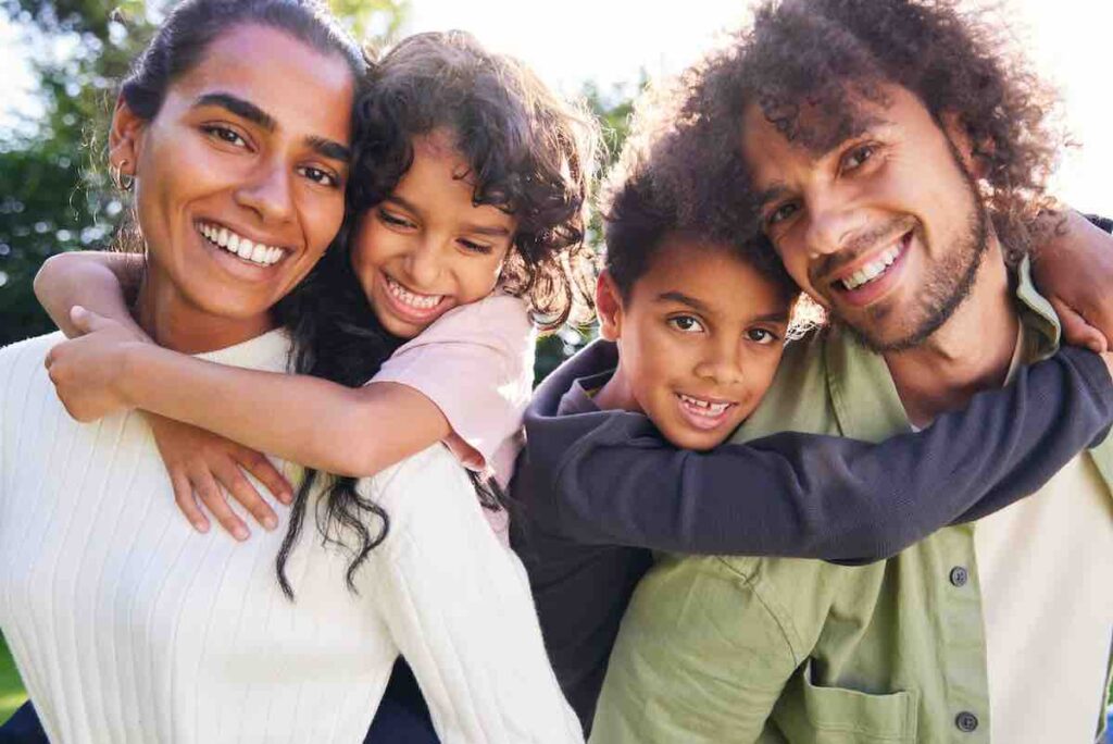 Smiling family embracing, representing recovery & mental health support